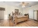 Bright bedroom featuring a king-size bed and wood floors at 1287 Glendora Rd, Kissimmee, FL 34759