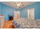 Cozy bedroom featuring blue walls, wood floors, and direct access to the ensuite bathroom at 1819 Coriander Dr # 1819, Kissimmee, FL 34759