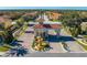 Aerial view of community gate with fountain, lush trees, and terra cotta roofs at 1819 Coriander Dr # 1819, Kissimmee, FL 34759