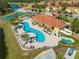 Aerial view of community pool and amenity center, surrounded by lush landscaping at 1819 Coriander Dr # 1819, Kissimmee, FL 34759
