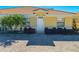 Exterior view of home featuring decorative landscaping, symmetrical design, and a terra cotta roof at 1819 Coriander Dr # 1819, Kissimmee, FL 34759