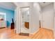 Hallway leading to a brightly-painted bedroom and bathroom featuring tiled floors and modern fixtures at 1819 Coriander Dr # 1819, Kissimmee, FL 34759