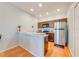 Modern kitchen features stainless steel appliances, breakfast bar, and recessed lighting at 1819 Coriander Dr # 1819, Kissimmee, FL 34759