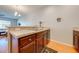 Eat-in kitchen featuring modern countertops, wooden cabinets, and stainless steel double sink at 1819 Coriander Dr # 1819, Kissimmee, FL 34759