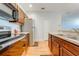 Well-equipped kitchen with modern appliances, wooden cabinets, and laminate wood flooring at 1819 Coriander Dr # 1819, Kissimmee, FL 34759