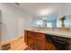 Eat-in kitchen with modern countertops, stainless steel sink, and views into the open-concept living area at 1819 Coriander Dr # 1819, Kissimmee, FL 34759