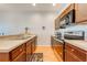 Modern kitchen with stainless steel appliances, including a range and microwave, and sleek wooden cabinets at 1819 Coriander Dr # 1819, Kissimmee, FL 34759