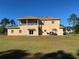 A home's backyard features a second story balcony, a covered patio, and an outdoor seating area at 20526 Quinella St, Orlando, FL 32833