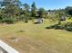Expansive backyard with mature trees, shed, and sunny lawn at 20526 Quinella St, Orlando, FL 32833
