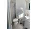 Bright bathroom featuring marble tile, a single vanity, and a shower with curtain at 20526 Quinella St, Orlando, FL 32833