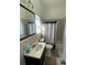 Well-lit bathroom with a shower-tub combo, tile flooring, and a modern vanity at 20526 Quinella St, Orlando, FL 32833
