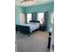 Bedroom with a dark bed frame and furniture, with carpet and blue accent wall at 20526 Quinella St, Orlando, FL 32833