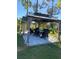 Outdoor gazebo with dining table, chairs, and privacy curtains in a green yard at 20526 Quinella St, Orlando, FL 32833