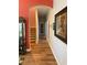Hallway leading to the stairs, with wooden floors and framed artwork at 20526 Quinella St, Orlando, FL 32833