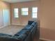 Large living room with peach walls, carpeted floors, and a large gray sectional couch at 20526 Quinella St, Orlando, FL 32833