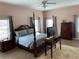 Spacious main bedroom with hardwood floors, a four-poster bed, and plenty of natural light at 20526 Quinella St, Orlando, FL 32833