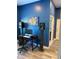 Office space with wood flooring, blue walls, and room for a computer setup at 20526 Quinella St, Orlando, FL 32833