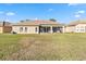 Home with backyard and screened porch at 3634 Northwoods Dr, Kissimmee, FL 34746