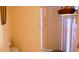 Powder room featuring cream walls, a shelf over the toilet, and a window with blinds at 101 Whitehall Way, Kissimmee, FL 34758