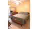 Bedroom features a queen bed, dresser with mirror, and ceiling fan at 101 Whitehall Way, Kissimmee, FL 34758