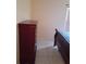 Bedroom features a wood dresser next to the bed and a window at 101 Whitehall Way, Kissimmee, FL 34758