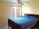 Well-lit bedroom with a ceiling fan, featuring neutral walls, a bright atmosphere, and comfortable bedding at 101 Whitehall Way, Kissimmee, FL 34758