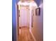 Hallway showcasing the hardwood floors, neutral wall color, and closet doors at 101 Whitehall Way, Kissimmee, FL 34758