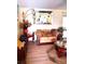 Cozy living room area showcasing a love seat, decorative mirror and hardwood floors at 101 Whitehall Way, Kissimmee, FL 34758