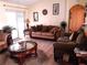Comfortable living room with a plush brown sofa set and a view of the outdoors at 101 Whitehall Way, Kissimmee, FL 34758
