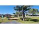 Palm Park community swings with safety surfaces and lush trees, promoting outdoor fun at 2606 Royal Fern Pl, Kissimmee, FL 34758