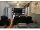 Cozy living room featuring leather seating, TV, and built-in bookcase at 2606 Royal Fern Pl, Kissimmee, FL 34758