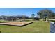 A community playground with seating, a large shade canopy, and a sign, offering a fun outdoor space for children at 2606 Royal Fern Pl, Kissimmee, FL 34758