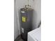 Standard water heater located adjacent to the laundry area at 316 Poinciana Cir, Kissimmee, FL 34744