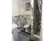 Nicely remodeled bathroom featuring modern marble style tile and a shower with glass door at 7024 Moderna Way, Orlando, FL 32822