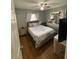 Bedroom features hardwood flooring, large windows, and a neutral color scheme at 7024 Moderna Way, Orlando, FL 32822