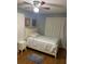 Bedroom with wood floors, ceiling fan, and neutral paint at 7024 Moderna Way, Orlando, FL 32822