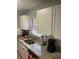 Kitchen showcasing granite countertops, stainless sink and appliances, and white cabinets at 7024 Moderna Way, Orlando, FL 32822