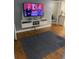 Living room with sleek shelving, hardwood floors, and large area rug at 7024 Moderna Way, Orlando, FL 32822