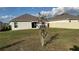 Backyard with a tree, lawn, and white fence provides privacy and room to relax and play outdoors at 741 Watusi Way, Saint Cloud, FL 34772