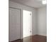 Bedroom with hardwood floors and access to bathroom at 8846 Coral Palms Ct # A, Kissimmee, FL 34747