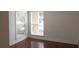Bedroom with hardwood floors and two windows at 8846 Coral Palms Ct # A, Kissimmee, FL 34747