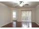 Spacious bedroom with hardwood floors and access to a balcony at 8846 Coral Palms Ct # A, Kissimmee, FL 34747