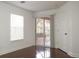 Bright bedroom with hardwood floors and sliding glass door to patio at 8846 Coral Palms Ct # A, Kissimmee, FL 34747