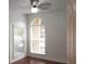 Bedroom with wood floors, large window, and ceiling fan at 8846 Coral Palms Ct # A, Kissimmee, FL 34747