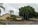 Community view showcasing lush landscaping, mature trees, and well-maintained signage at the entrance at 8846 Coral Palms Ct # A, Kissimmee, FL 34747