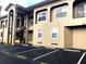 Condo building exterior with visitor parking, multiple units, and convenient outdoor staircases for upper-level access at 8846 Coral Palms Ct # A, Kissimmee, FL 34747