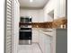 Updated kitchen with stainless steel appliances and tile backsplash at 8846 Coral Palms Ct # A, Kissimmee, FL 34747