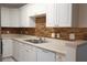 Modern kitchen with white cabinets and a stylish backsplash at 8846 Coral Palms Ct # A, Kissimmee, FL 34747