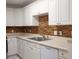 Modern kitchen with white cabinets and a stylish backsplash at 8846 Coral Palms Ct # A, Kissimmee, FL 34747
