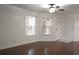 Spacious living area with hardwood floors and large windows at 8846 Coral Palms Ct # A, Kissimmee, FL 34747